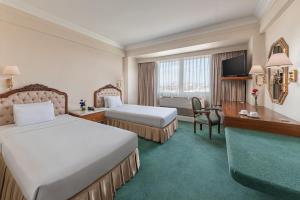 马尼拉马尼拉王子酒店的酒店客房配有两张床和一张书桌