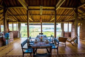 WatukarungBatu Hill Villa的一间带木桌和椅子的用餐室