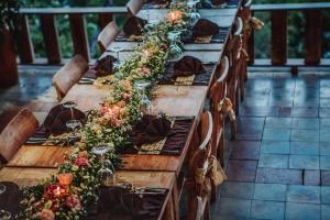 德格拉朗彭杜克塞巴图别墅酒店的一张长木桌子,上面有鲜花