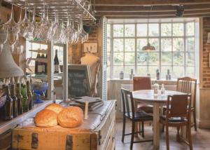 BrabourneThe Five Bells Inn的厨房配有桌子和带面包的桌子