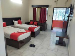 KushinagarHOTEL BUDDHA的酒店客房,设有两张床和一张沙发