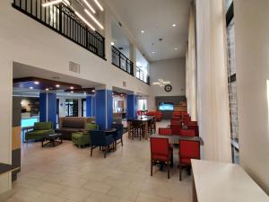 格伦代尔Holiday Inn Express & Suites Phoenix Glendale Dist, an IHG Hotel的医院的大厅,配有桌椅