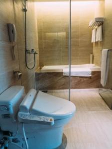 头份市尚顺君乐饭店的浴室配有蓝色卫生间和淋浴。