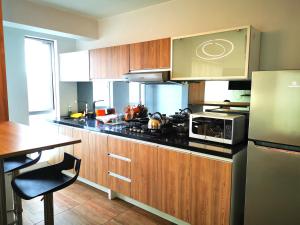 利马Residencial Cafferata的厨房配有木制橱柜和炉灶烤箱。