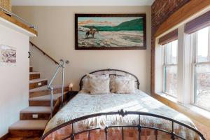 杜兰戈Jarvis #303的卧室配有一张床,墙上挂有绘画作品