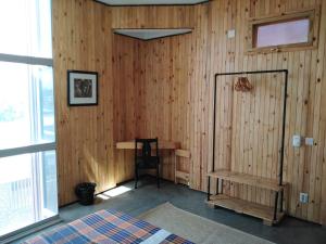 马普托Museu Mafalala B&B的卧室设有木墙、一张床和窗户