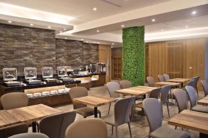 台中市逢甲微行商旅的一间带桌椅和绿色墙壁的餐厅