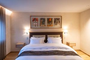 萨尔格米纳Auberge Saint Walfrid Hôtel Restaurant & Spa的卧室配有一张带两个枕头的大白色床