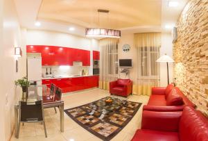 基辅亚历克斯公寓酒店 - 靠近独立广场 - 基辅的一间带红色家具的客厅和一间厨房