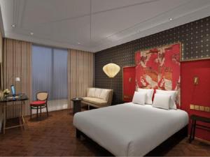 宝山区锦江都城上海殷高路地铁站酒店的酒店客房设有一张大床和一张书桌。