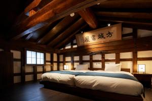 仙北Wanoi Kakunodate的一间带一张大床的卧室,位于一个拥有木制天花板的房间
