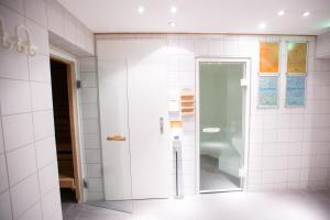 美因河畔法兰克福Crowne Plaza Frankfurt Congress Hotel, an IHG Hotel的浴室设有玻璃淋浴间,拥有白色瓷砖墙壁