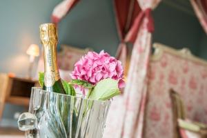 尚托奈珀塞庄园酒店的一张桌子上装着粉红色花的花瓶