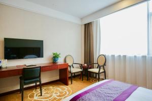 上海新爵皇家酒店的酒店客房配有桌椅和电视。