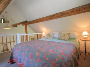 QueningtonMayfly Cottage的一间卧室配有一张带彩色毯子的床