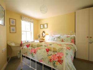 阿尔维斯考特Garden Cottage的一间卧室,床上放着鲜花