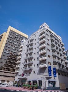 迪拜MENA Plaza Hotel Albarsha At The Mall的一座大型白色建筑,其侧面设有阳台