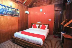 亭可马里Trinco Star Cabana的一间设有床铺的卧室,位于一个红色墙壁的房间