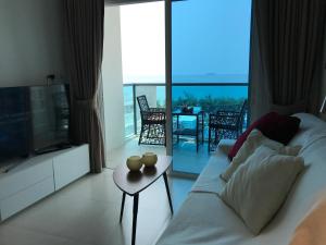 梅尔皮姆GrandBlue Condominium Mae Phim TOP FLOOR WITH SEA VIEW 706的带沙发、电视和桌子的客厅