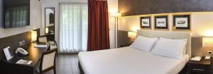 福尔米吉内摩德纳贝斯特韦斯特度假酒店的酒店客房设有一张大床和一张书桌。