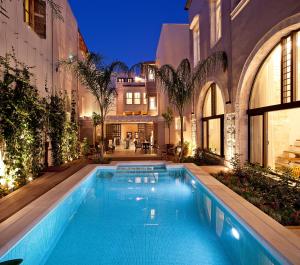 罗希姆诺里蒙迪精品酒店 - 世界小型豪华酒店的一座建筑物中央的游泳池