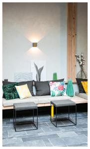 马赛URBAN LOFT & SPA Marseille的一张沙发,里面配有色彩缤纷的枕头和桌子
