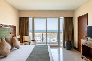 穆萨纳Barceló Mussanah Resort, Sultanate of Oman的酒店客房设有一张床和一个大窗户