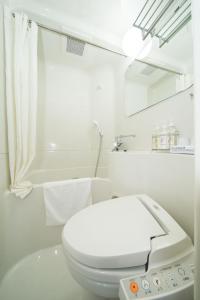 奈良Super Hotel Premier JR Nara Eki的白色的浴室设有卫生间和电话。