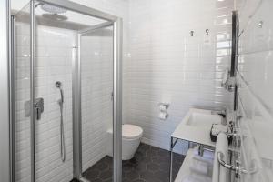 瓦莱塔La Falconeria Hotel的带淋浴、卫生间和盥洗盆的浴室