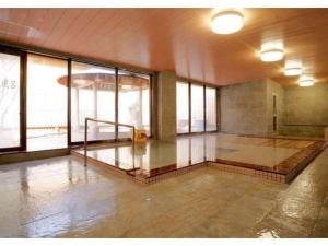 仙北Tazawako Lake Resort & Onsen / Vacation STAY 78938的建筑物地板上空空的有水的房间