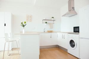 桑坦德Estilo nordico Sardinero的白色的厨房配有水槽和洗衣机