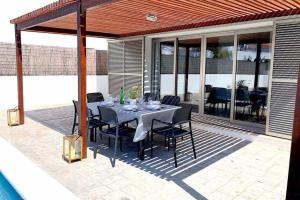 卡兰博希Villa d’Aina * Propiedad privada con piscina的庭院里的餐桌和椅子