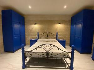 森格莱阿Cosy private townhouse in heart of Senglea的蓝色卧室,配有一张蓝色橱柜床