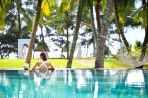 三亚海南清水湾莱佛士酒店 的坐在游泳池里的比基尼女人