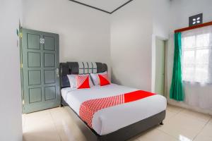 武吉丁宜OYO 2903 Putri Residence Syariah的一间卧室设有一张床和一个绿门