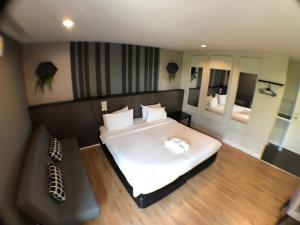 莱卡邦帕拉冈酒店的卧室配有一张白色的大床和一张沙发。