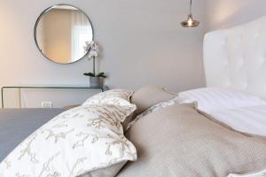 扎达尔Shell Luxury Residences with Pool and Whirlpool的一间卧室配有一张带镜子和枕头的床