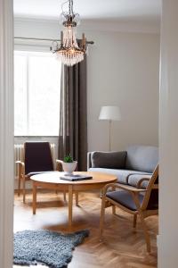 维斯比思科那荣誉公寓的客厅配有桌子和沙发