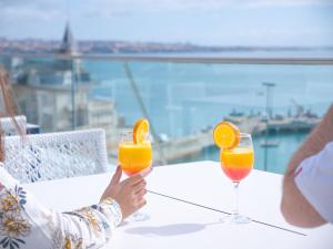 卡斯卡伊斯拜亚酒店的两人坐在桌子上,喝两杯橙汁