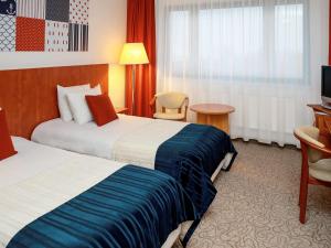 格丁尼亚美居中心酒店客房内的一张或多张床位
