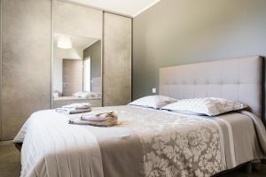 巴斯蒂亚Villa du Macchione BASTIA的一间卧室配有一张大床和大镜子