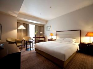 名古屋名古屋美居酒店的酒店客房设有一张大床和一张书桌。