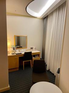 岐阜韦尔吉赞大酒店的办公室设有桌子、两把椅子和窗户