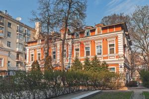 莫斯科Axis.Moscow Island的一座橘色和白色的建筑,前面有树木