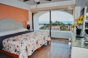 伊斯塔帕ENNA INN IXTAPA DEPARTAMENTOS ViSTA AL MAR的一间卧室设有一张床和一个阳台