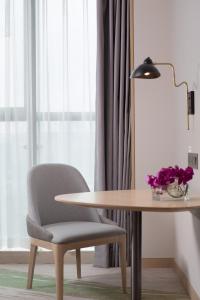 贵阳贵阳南岳假日酒店的一张桌子、椅子、一张桌子和一盏灯