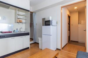大阪上汐中央方舟公寓的厨房配有白色冰箱和桌子