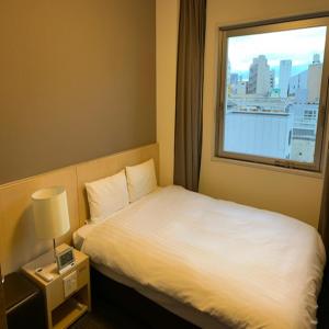 甲府多美迎甲府酒店的酒店客房设有床和窗户。