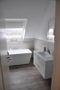 哈恩Sterner Obgruiten的带浴缸、水槽和窗户的浴室