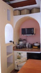 提华纳Greek Cottage Playas de Tijuana的厨房配有带水槽和微波炉的台面